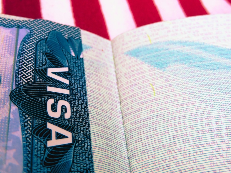 Passport book with Visa paper open on red and white stripes