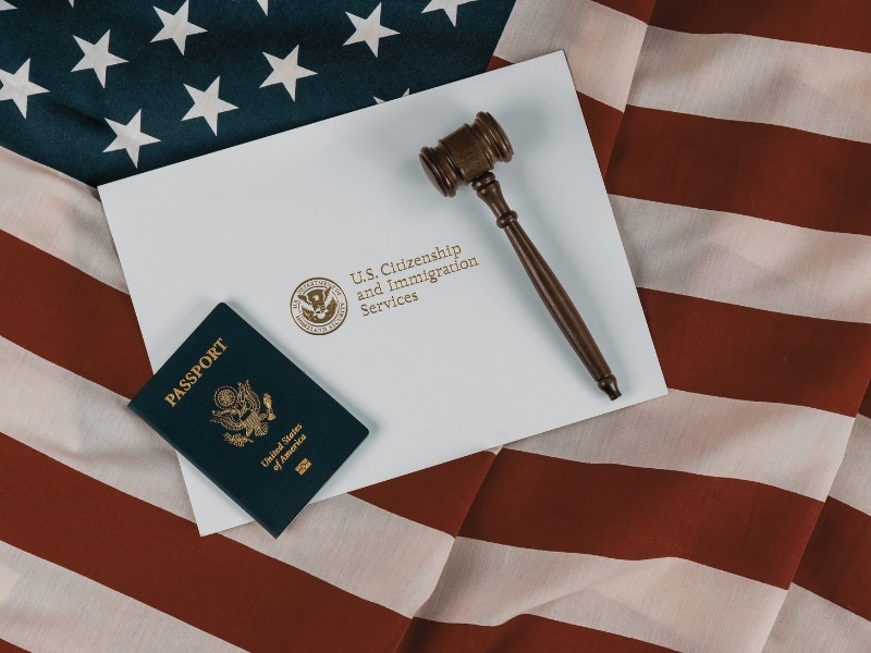 US Passports with wooden judge gavel on American flag on legal world