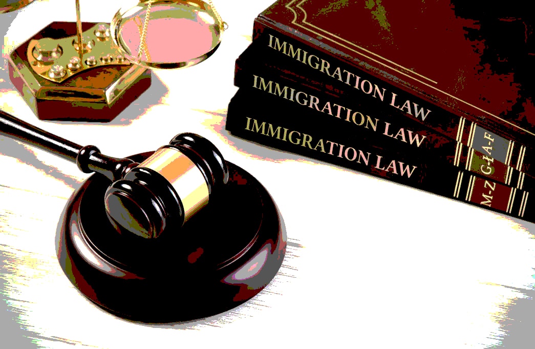 immigration law books, a gavel and Justice on a desk to help know what to ask immigration lawyer