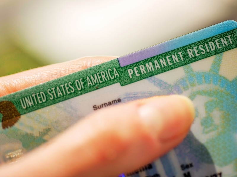 Close up view of Permanent resident card (Green) card of USA on blurred background.