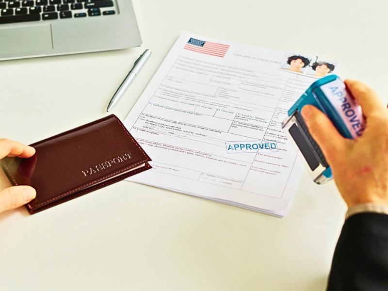 Close up of immigration office worker approving visa application. visa options for entrepreneurs