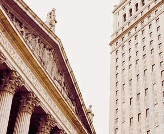 a classical building with large columns and an inscription that reads, "ADMINISTRATION OF JUSTICE IS THE FIRMEST PILLAR OF GOOD GOVERNMENT," indicating a judicial or governmental purpose. Writ of Mandamus for Immigration Delays