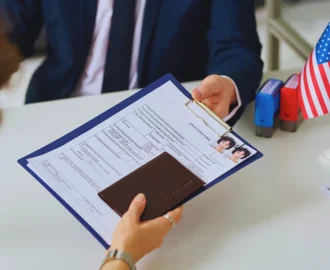 A person handing over an application form and passport. Asylum Work Permit Changes
